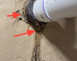 Main Sewer Line – Seepage at the Wall Penetration Corroded cast iron to plastic sewer transition with staining at a basement wall penetration