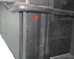End of a structural beam resting on a slender vertical wood member rather than proper bearing