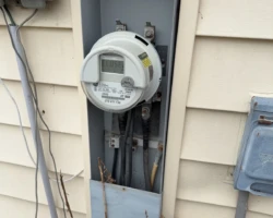 Electric Meter – Lower Enclosure Cover Missing Exterior electric meter enclosure with the lower cover absent and wiring visible