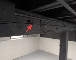 Longitudinal crack running along the face of a wooden structural beam