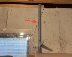 Vertical crack running through a poured concrete foundation wall
